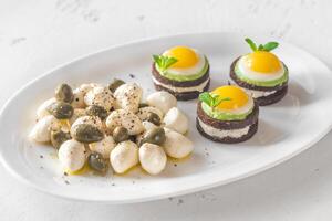 Appetizer with canape, mozzarella and capers photo