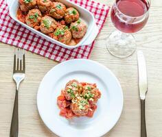 Meatballs with tomato sauce and parmesan photo