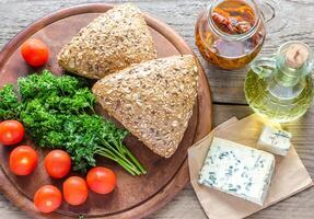 Flax-seed buns with blue cheese and tomatoes photo