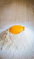 Broken egg in flour photo