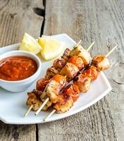 Grilled chicken skewers with cherry tomatoes photo