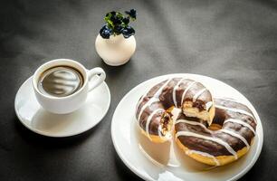 Chocolate donuts with a cup of coffee photo