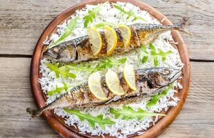 Grilled mackerel with basmati rice and fresh arugula photo