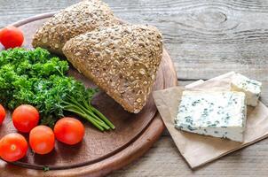 Flax-seed buns with blue cheese and tomatoes photo