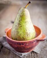 Green pear in rustic decor photo