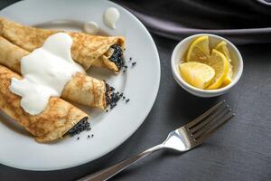 Crepes with black caviar photo