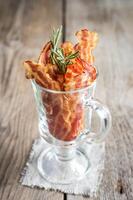 Fried bacon strips with fresh rosemary photo