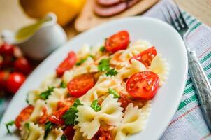 Farfalle pasta with cherry tomatoes photo