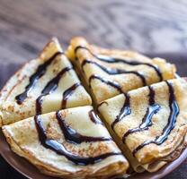 Crepes with chocolate topping photo
