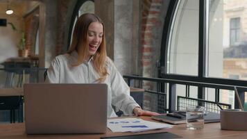 Happy excited Caucasian woman worker business female employer designer girl businesswoman celebrate good result spinning whirl on office chair dancing thumbs up financial success complete work smile video