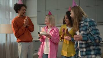 Birthday happy party at home multiracial friends multiethnic diversity people singing festive song congratulate Caucasian woman girl female holding cake blowing candles wishing birth celebration joy video