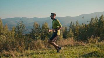 Side view fitness Caucasian male man guy running active cardio sport exercise trail hike runner traveler exploring path athlete sportsman outside sunny wild green nature activity healthcare travelling video