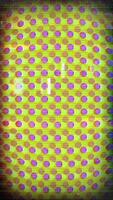 a television screen with a pattern of yellow and purple dots video