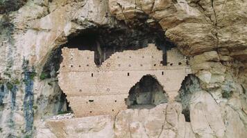 Drone footage displays ruins of ancient Christian three-story rock church, dating back to 7th century Eastern Roman Empire. highlights Christian heritage and historical significance of site video