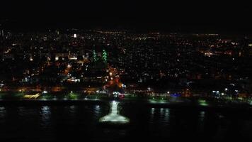 Panoramic drone view of Mersin, illuminated cityscape at night. Aerial footage captures illuminated cityscape, showcasing Mersin's night beauty. Night in Mersin, drone of illuminated cityscape video
