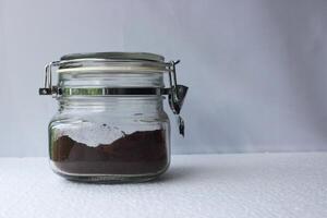 Jar of ground instant coffee on white background. photo