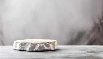 White stone pedestal podium on blurred gray background photo