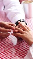 Happy moments when a man proposes to his girlfriend by giving a ring at a cafe. photo