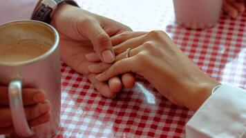 Happy moments when a man proposes to his girlfriend by giving a ring at a cafe. photo