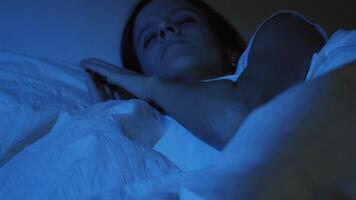 Beautiful girl sleeping cozily on a bed in her night room with Blue Colors from the moon. video