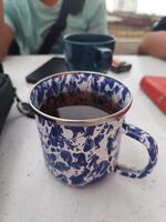 Hot tea that has been brewed in a traditional blue patterned cup photo