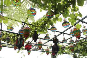 Turkish mosaic lamp Traditional oriental lamp hung with plants at the Farm House. photo