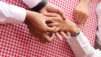 Happy moments when a man proposes to his girlfriend by giving a ring at a cafe. photo