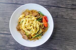 Processed fried vermicelli cooked with pieces of meat and eggs. The taste is spicy and savory. photo