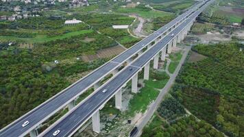 Drone footage of viaduct, valley, agricultural fields. Highlights ecology, viaduct's impact on ecology, agriculture's role in mountain ecology. Explores sustainable development video