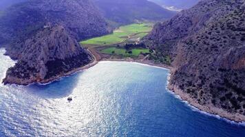 Panoramic aerial of Barboros Beach, Turkey, captures coastline, mountain essence. Coastal waves meet mountains, showcasing coastline, mountain harmony. Secluded beach framed by coastline video