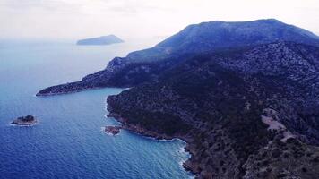 Aerial captures blend of mountain, sea, sky in Turkey, showcasing harmony of landscape. Scene reveals interaction of mountain, sea, sky in scenic view. video