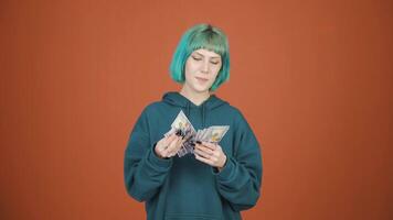 Young woman counting money looking at camera. video