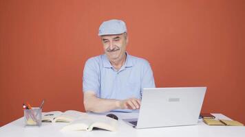 Man looking at laptop making positive gesture. video