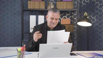 Businessman rejoicing at positive paperwork results. video