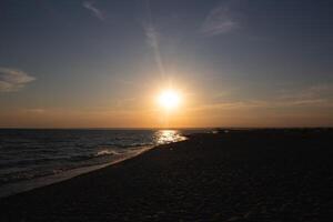 beautiful sunset on a sandy beach near the ocean. great background for design photo