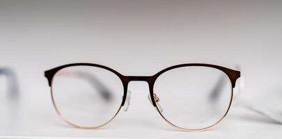 Modern eyeglasses on white isolated background. Vision eyesight accessory with black frame. photo