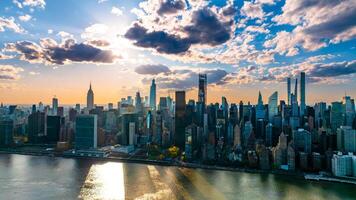 Skyline of modern New York, the USA. Majestic skyscrapers on the waterfront under the cloudy sky at daytime. photo