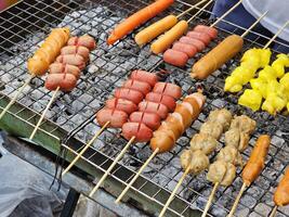 Sausage on skewers grilled over charcoal in Thai style. photo