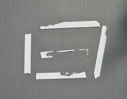 Old glue tape marks on the gray wall photo