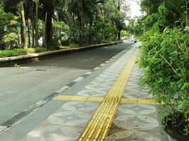 Surakarta, April 11 2024, quiet streets with lush trees and other public facilities around Manahan Stadium. photo