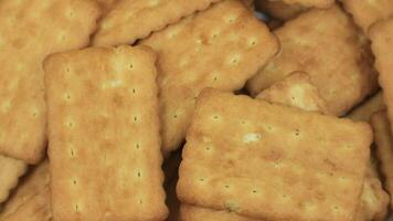 Pile of brown rectangular butter biscuits on rotary display video