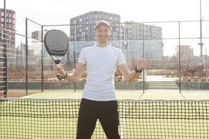 man playing paddle tennis court photo