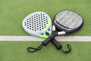 Paddle racket, next to the ball and on a carpet of the play area photo