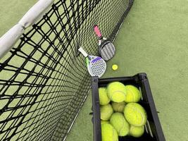 padel tennis racket sport court and balls. photo