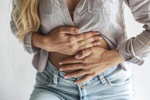 Young woman in menstrual pain, portrayal of the discomfort and agony experienced during menstruation, empathizing with the struggles of menstrual periods of cramps and distress. photo