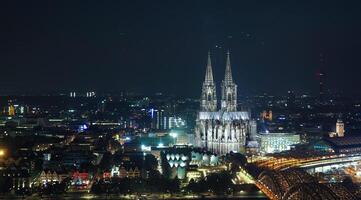 Aerial night view of St Peter Cathedral and Hohenzollern Bridge photo