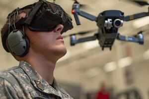 Drone operator using military drone on battlefield photo