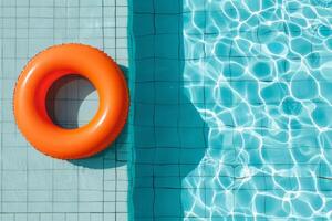 Inflatable Ring Floating in Clear Blue Swimming Pool on Sunny Day photo