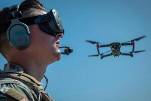 Drone operator using military drone on battlefield photo