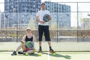 Ukraine Kyiv, April 02 2024. Padel training coach in a session, mentoring a female student, fostering skill development and a positive learning environment photo